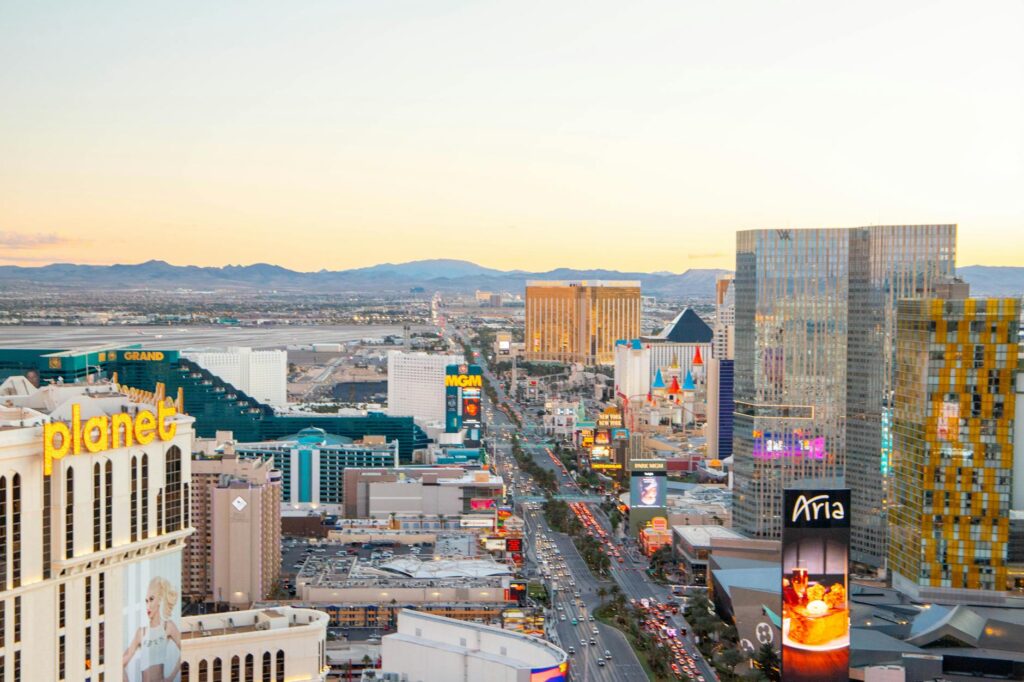 A bustling Las Vegas Strip view with budget accommodations visible in the background. — budget hotels in Las Vegas