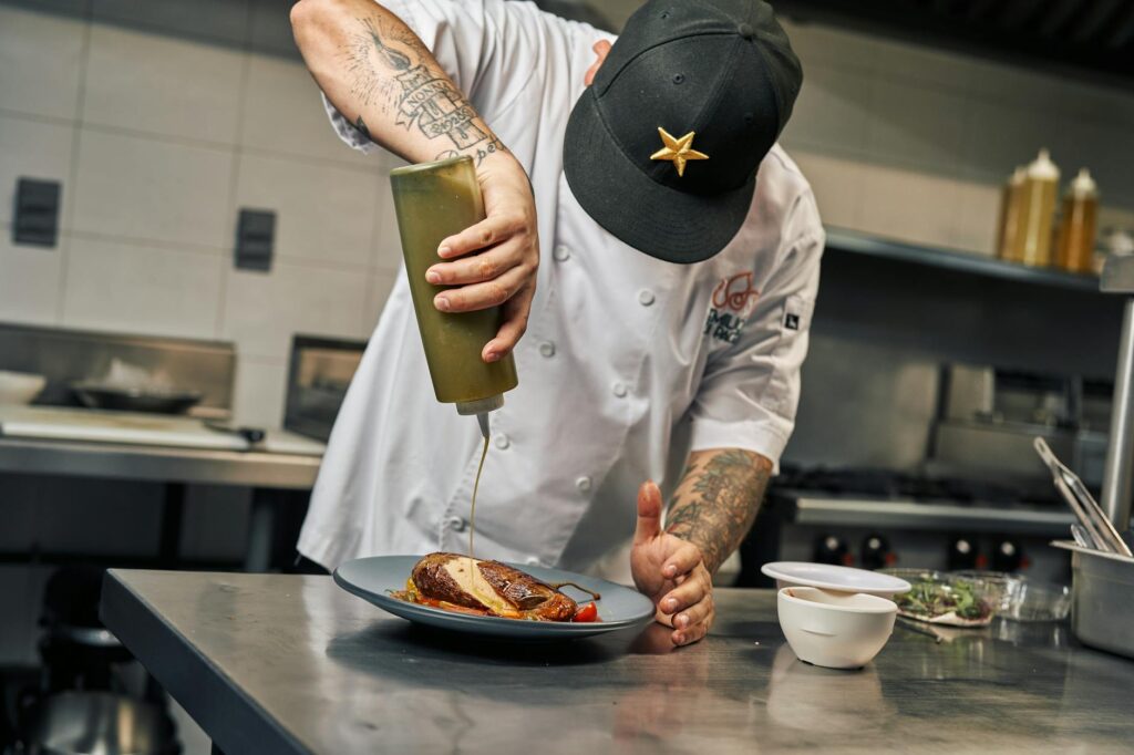 A bustling kitchen scene featuring a celebrity chef preparing a gourmet dish. — unique experiences in Las Vegas