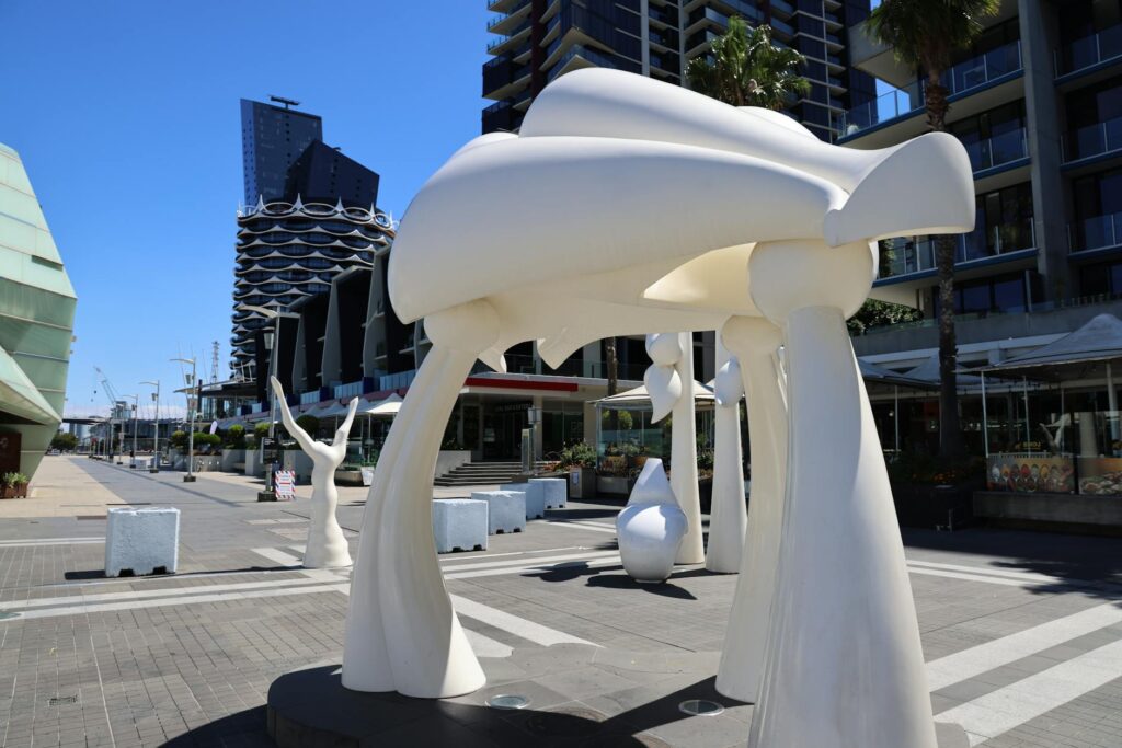 A cheerful traveler enjoying a public art installation. — save money Las Vegas vacation