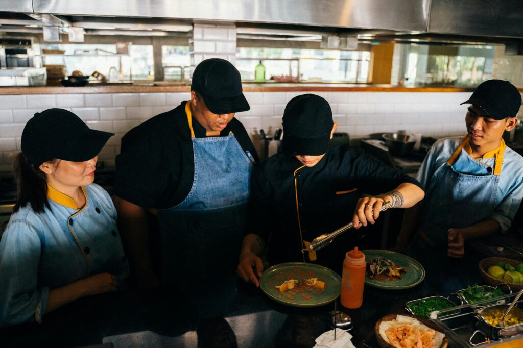 A chef preparing food in an upscale restaurant kitchen, emphasizing the culinary artistry involved. — best restaurants i…