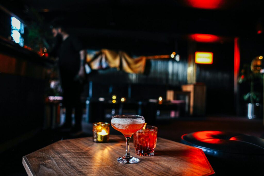A cozy, dimly lit bar featuring local artwork and unique cocktails, representing a hidden gem in Las Vegas. — hidden gem…