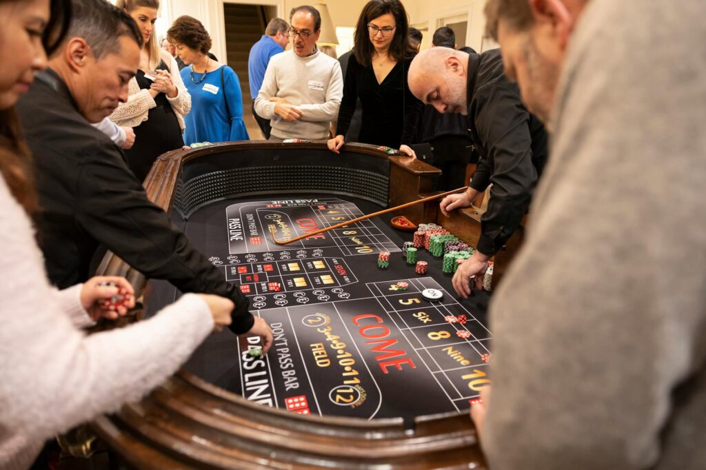 A craps table in action, capturing the dice roll and the energy of the crowd around it. — best odds casino games Las Vegas