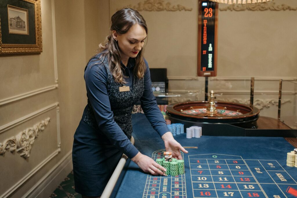 A dealer interacting with players at a table game, illustrating the importance of communication and respect, reflecting proper Las Vegas casino etiquette.