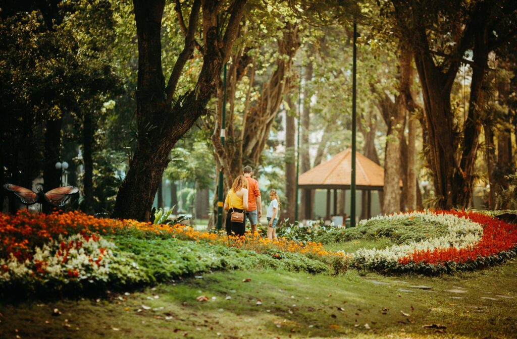 A family enjoying a tour at the Springs Preserve, surrounded by local flora — attractions off the Strip Las Vegas