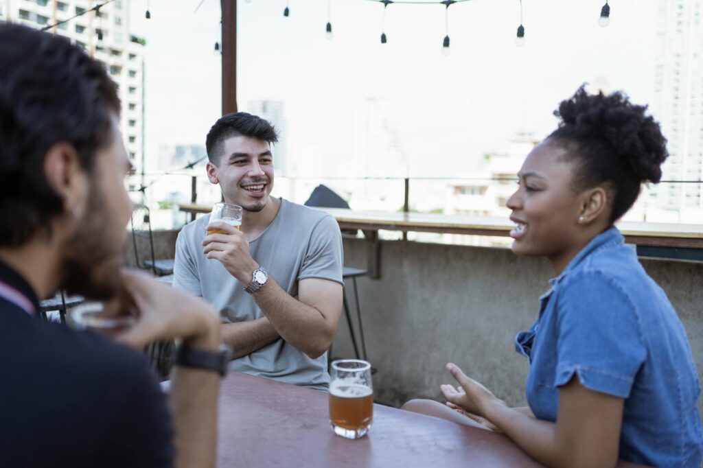 A group of friends enjoying drinks at a rooftop bar with a city view. — Las Vegas nightlife 2026