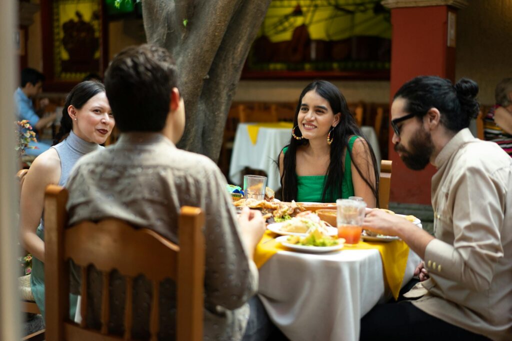 A group of friends enjoying their meal at an outdoor patio of a Las Vegas local restaurant. — local restaurants in Las V…