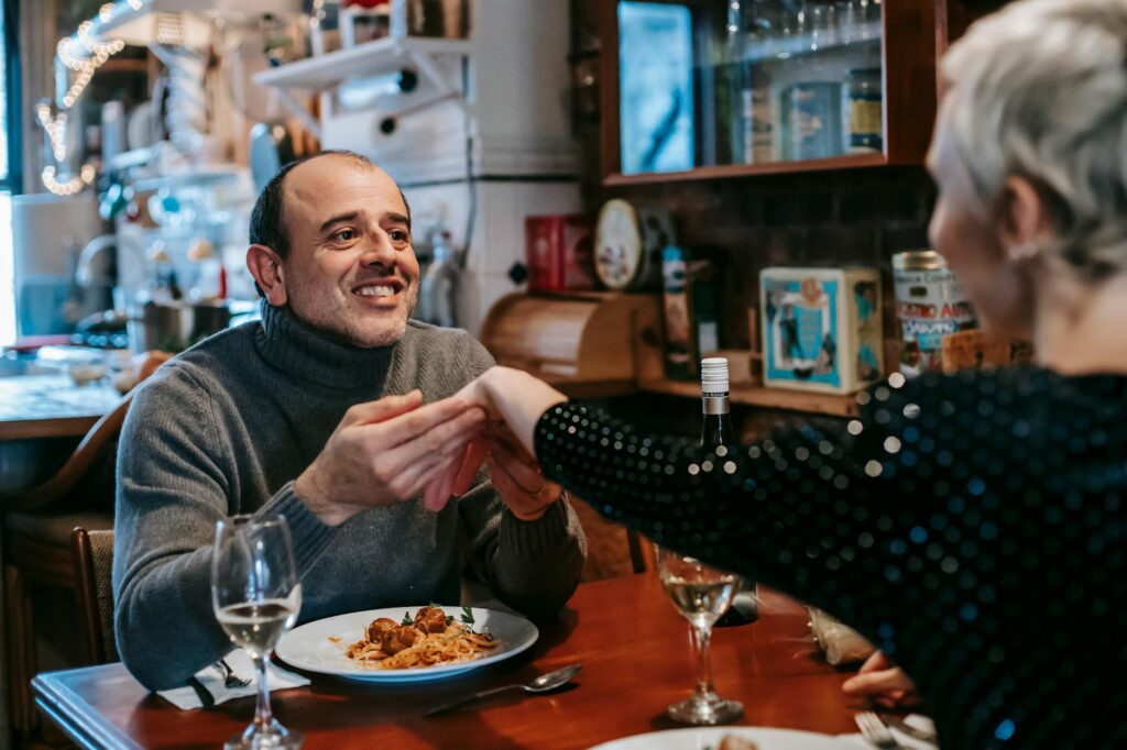 A happy couple enjoying a complimentary meal at a casino restaurant as a loyalty program benefit. — Las Vegas casino loy…