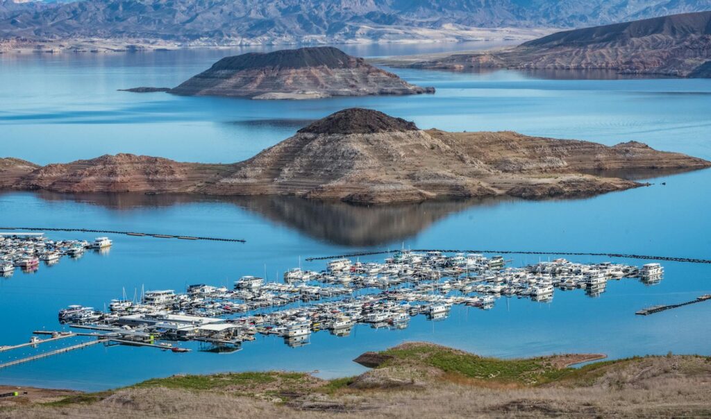 A scenic view of Lake Mead with people enjoying water activities — day trips from Las Vegas