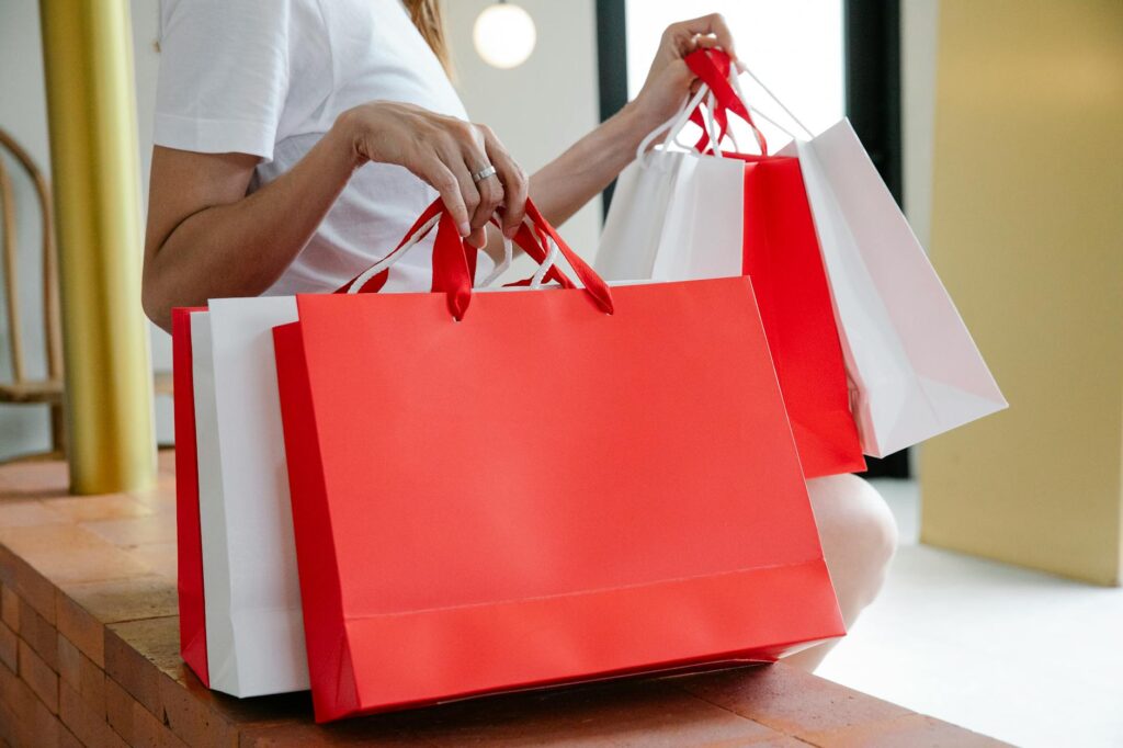 A shopper holding several shopping bags from popular Las Vegas stores. — Las Vegas shopping guide