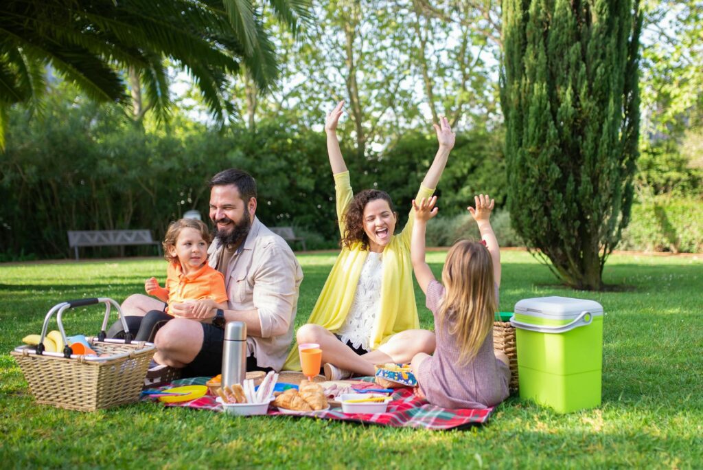 Families enjoying a picnic at a local Las Vegas park, surrounded by greenery. — free attractions Las Vegas families