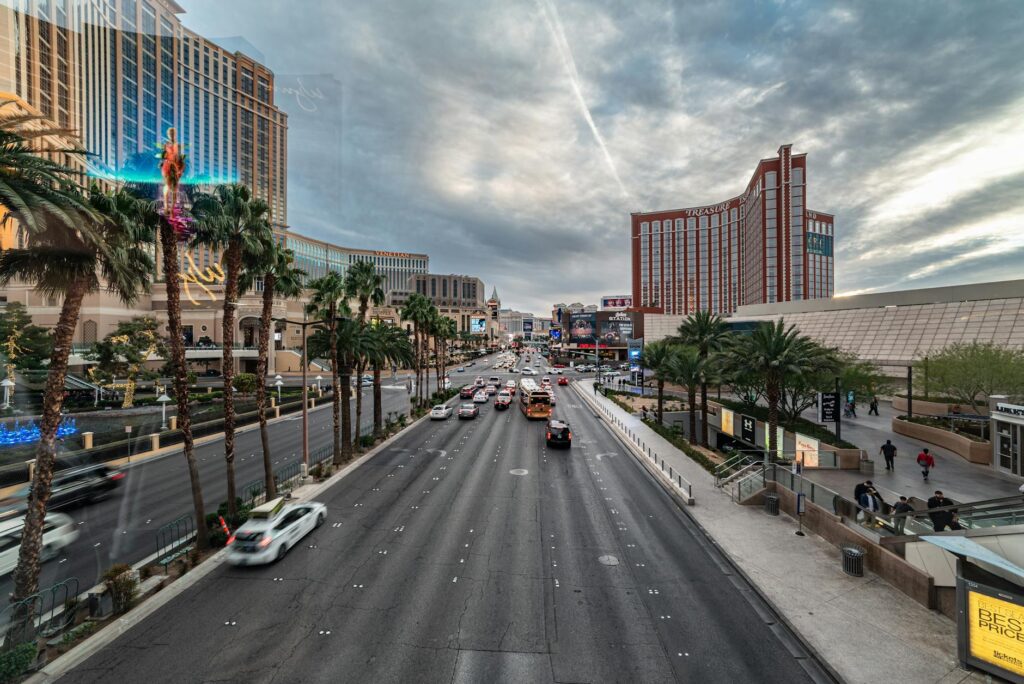 A busy Las Vegas Strip with pedestrians and transportation options in view — getting around Las Vegas