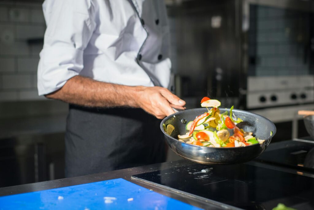 A celebrity chef demonstrating cooking techniques in a vibrant culinary class. — unique experiences in Las Vegas