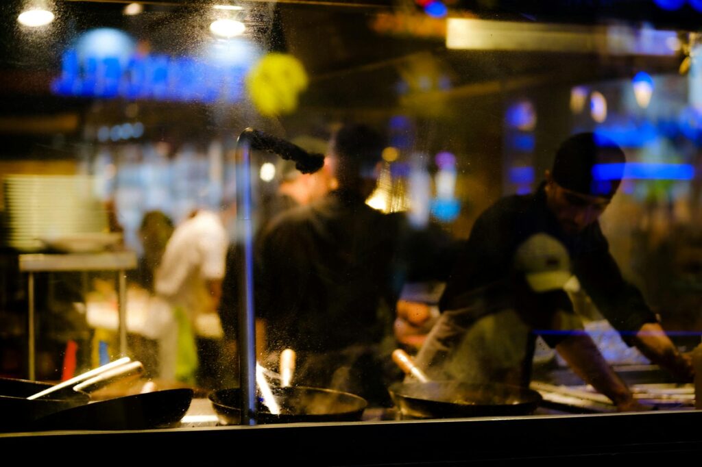 A chef preparing food at a live cooking station in a Las Vegas buffet, showcasing the interactive dining experience. — b…