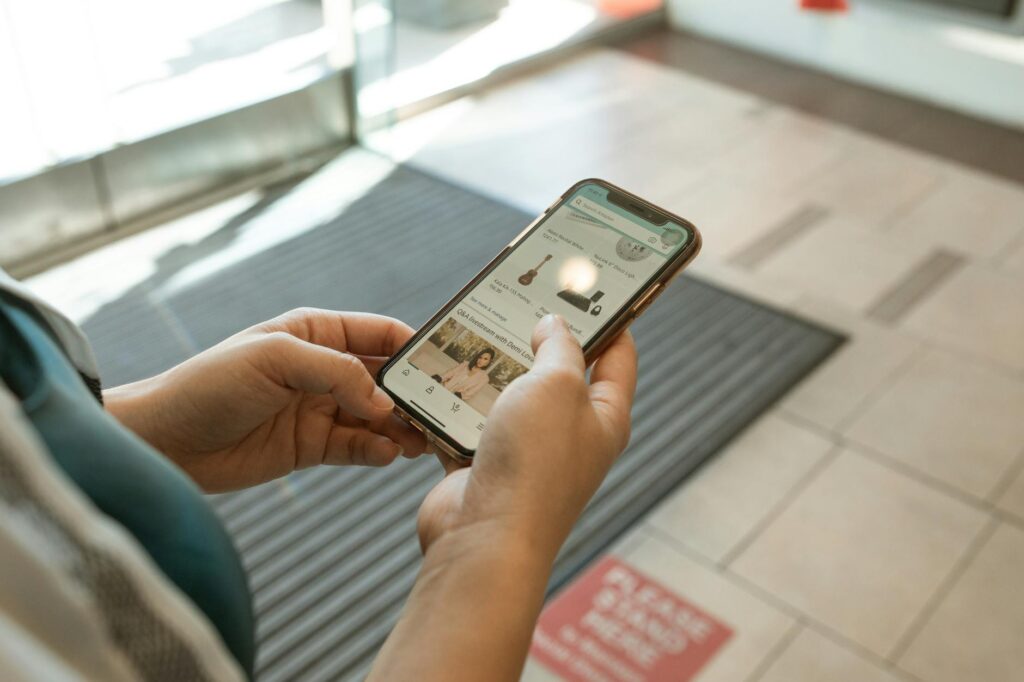 A close-up of a mobile phone displaying a ticket purchase app for Vegas shows. — last-minute Vegas show tickets