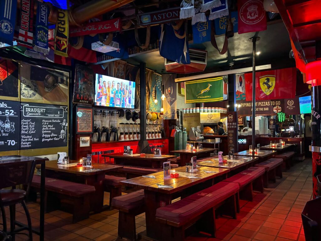 A cozy sports bar filled with fans watching a game on large screens, surrounded by memorabilia. — Las Vegas nightlife