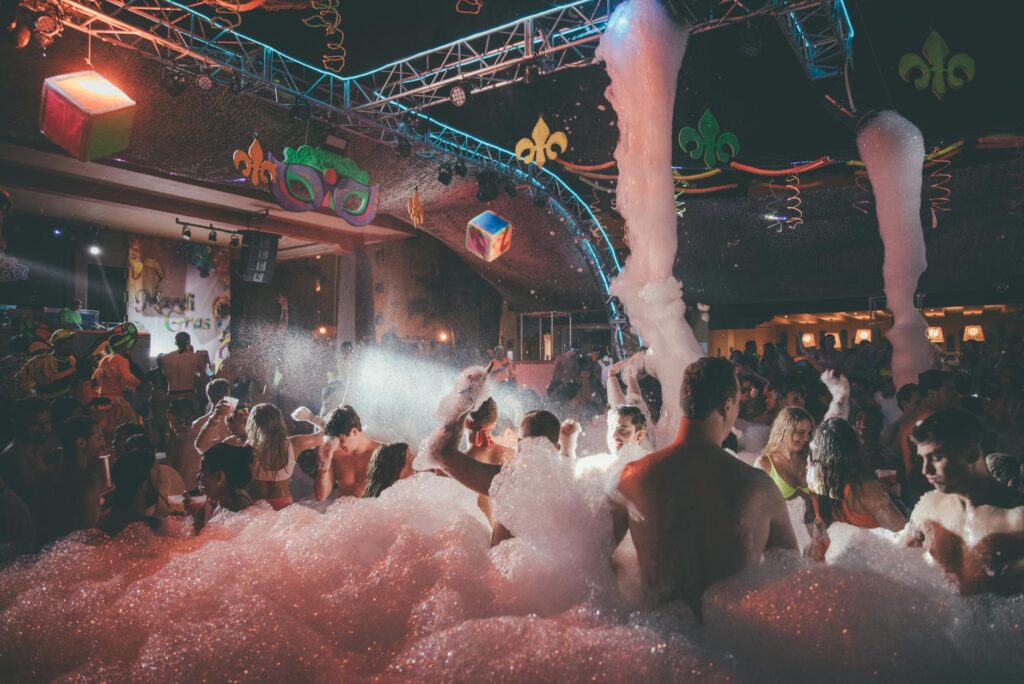A crowded Las Vegas nightclub with people dancing under colorful lights. — Las Vegas nightlife