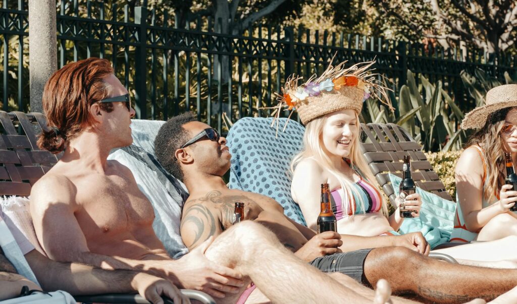 A group of friends at a pool party, enjoying drinks and the sun. — Vegas bachelor party planning