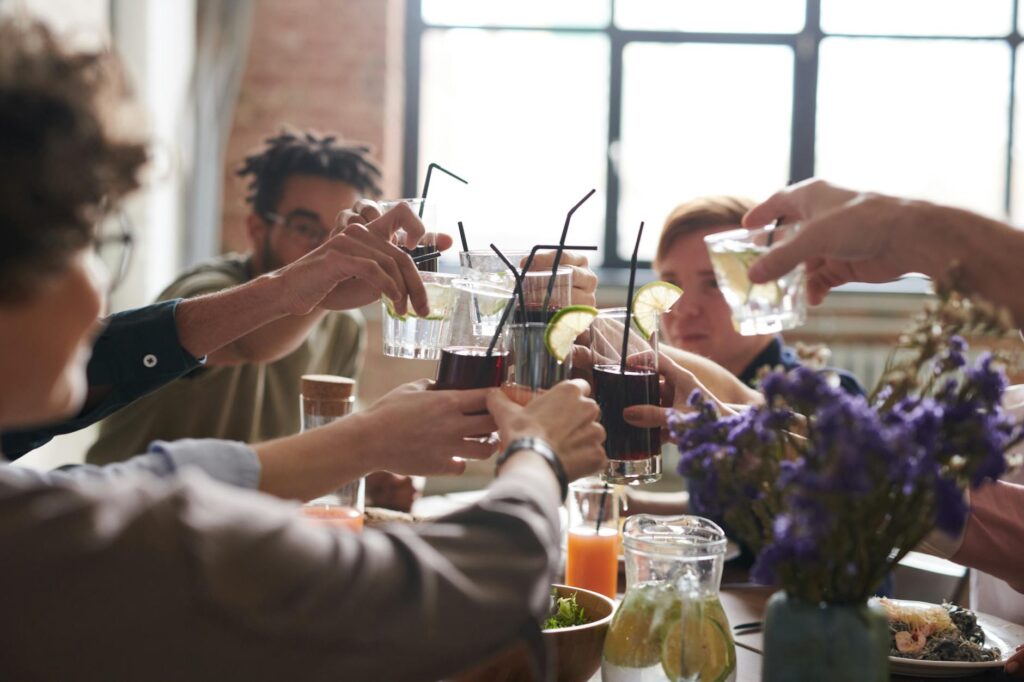 A group of friends raising their glasses for a toast over brunch, capturing the social aspect of dining in Las Vegas. — …