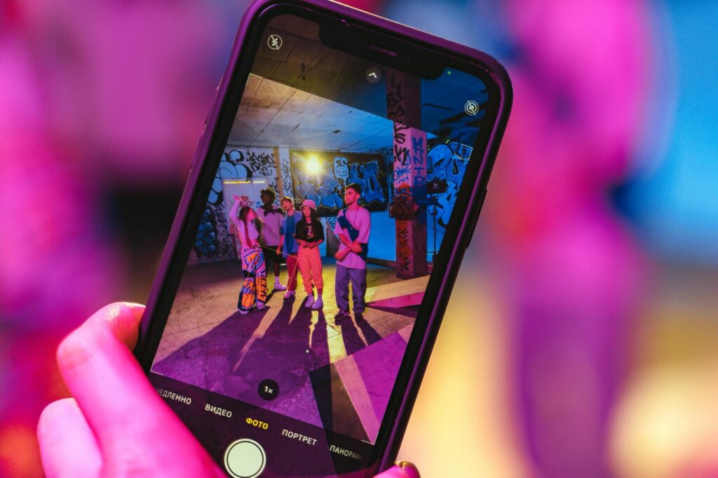 A group of friends taking a selfie at Fremont Street with vibrant lights in the background. — budget weekend in Las Vegas
