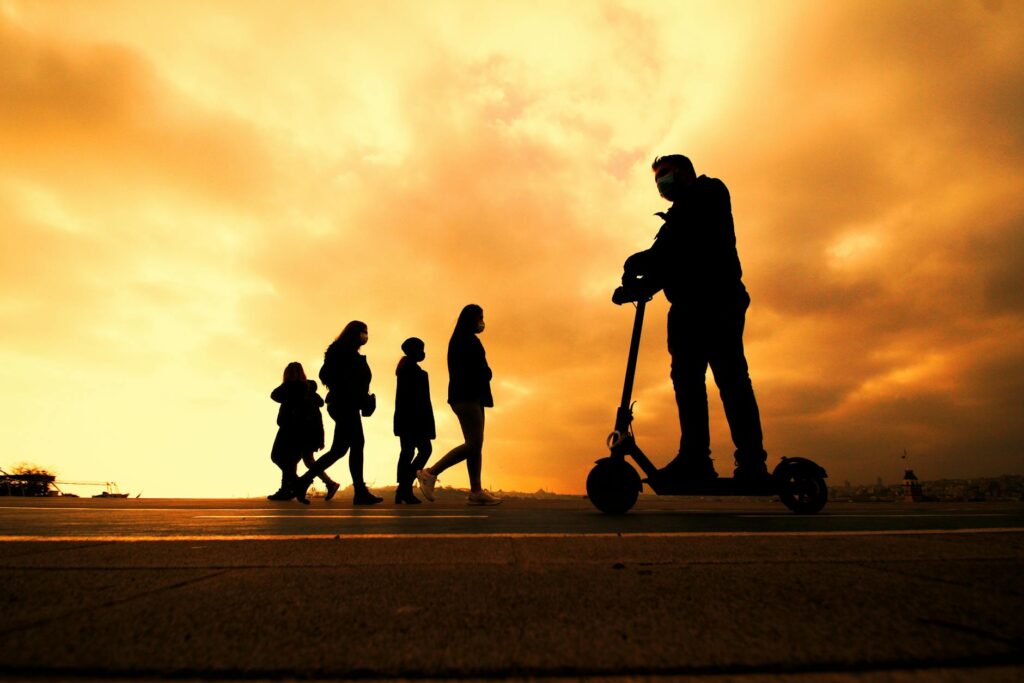A group of people riding electric scooters along a designated path in Las Vegas. — getting around Las Vegas