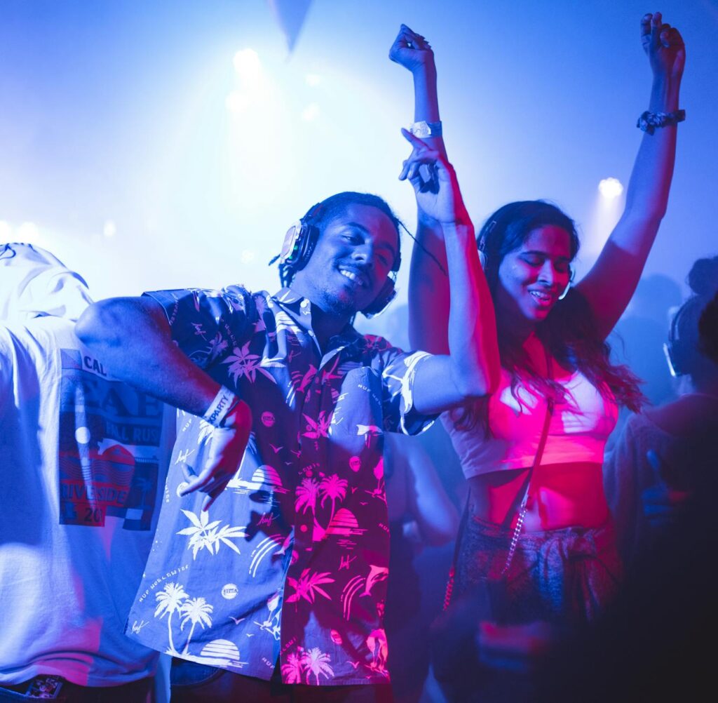 A happy couple enjoying a Vegas show, with the stage visible in the background. — last minute Las Vegas show tickets