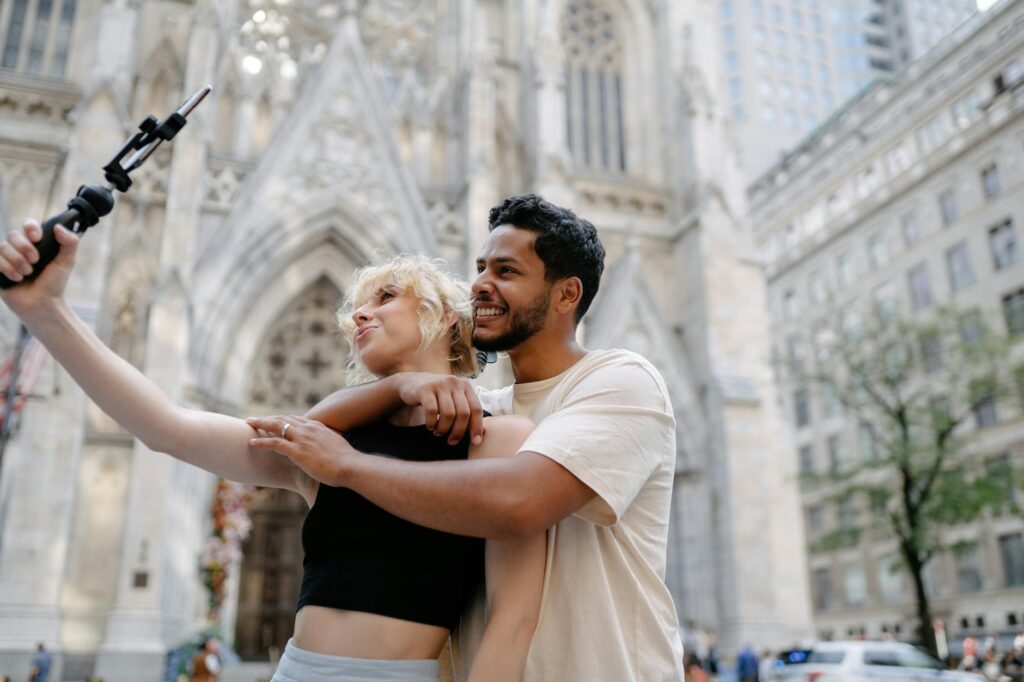 A happy couple taking a selfie in front of a famous Vegas landmark — Vegas weekend getaway budget