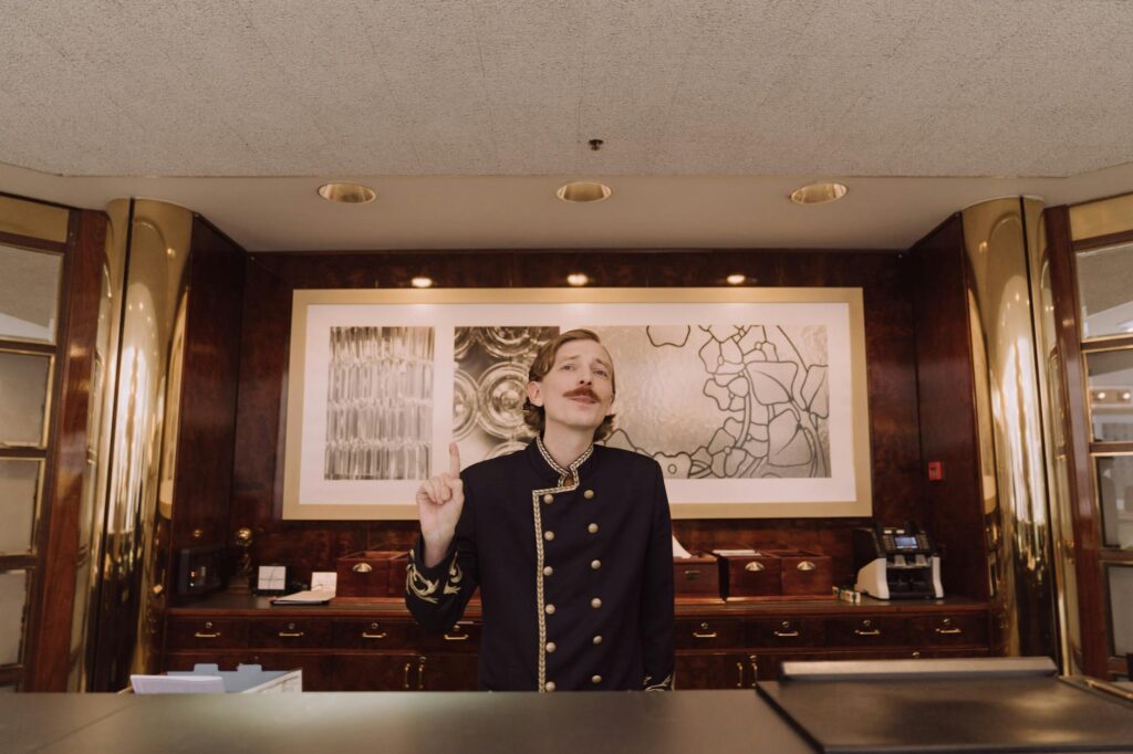A happy traveler checking into a hotel with a big smile, symbolizing satisfaction with great deals. — Las Vegas hotel de…