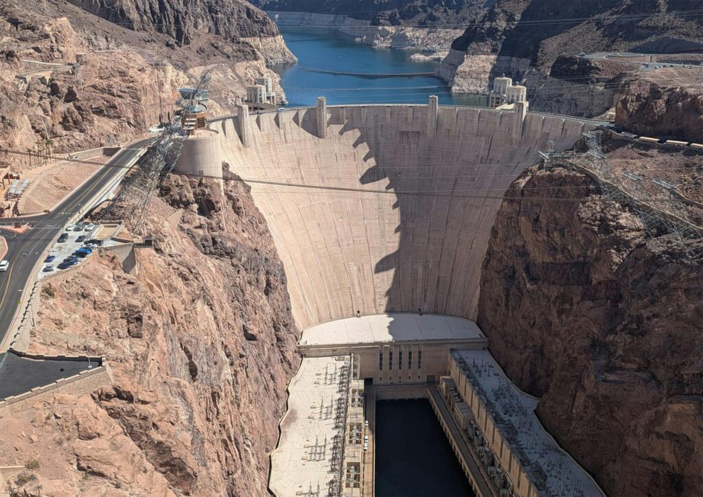 A panoramic shot of the Hoover Dam with Lake Mead in the background — day trips from Las Vegas