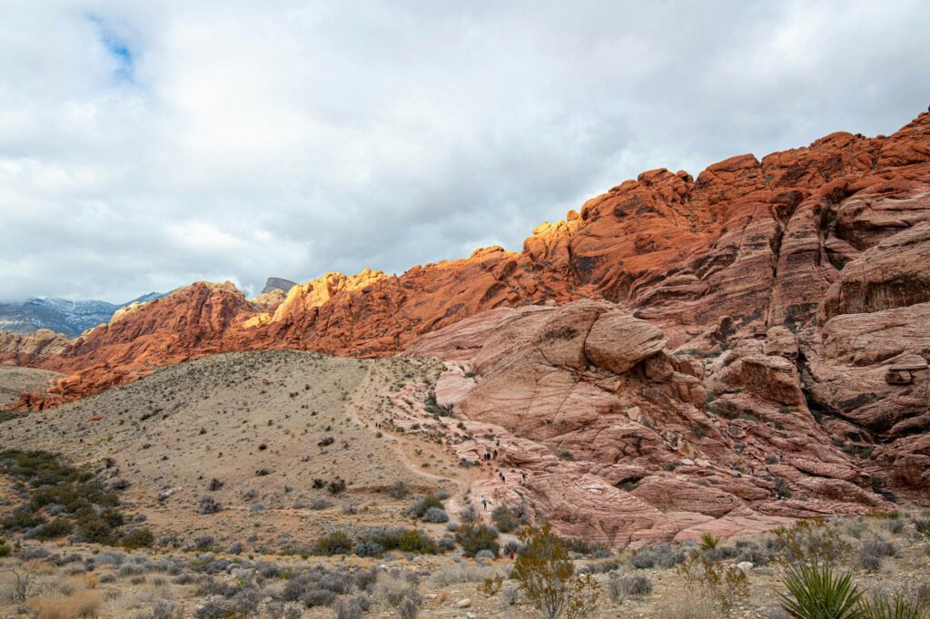 A scenic view of Red Rock Canyon showcasing its red rock formations — day trips from Las Vegas