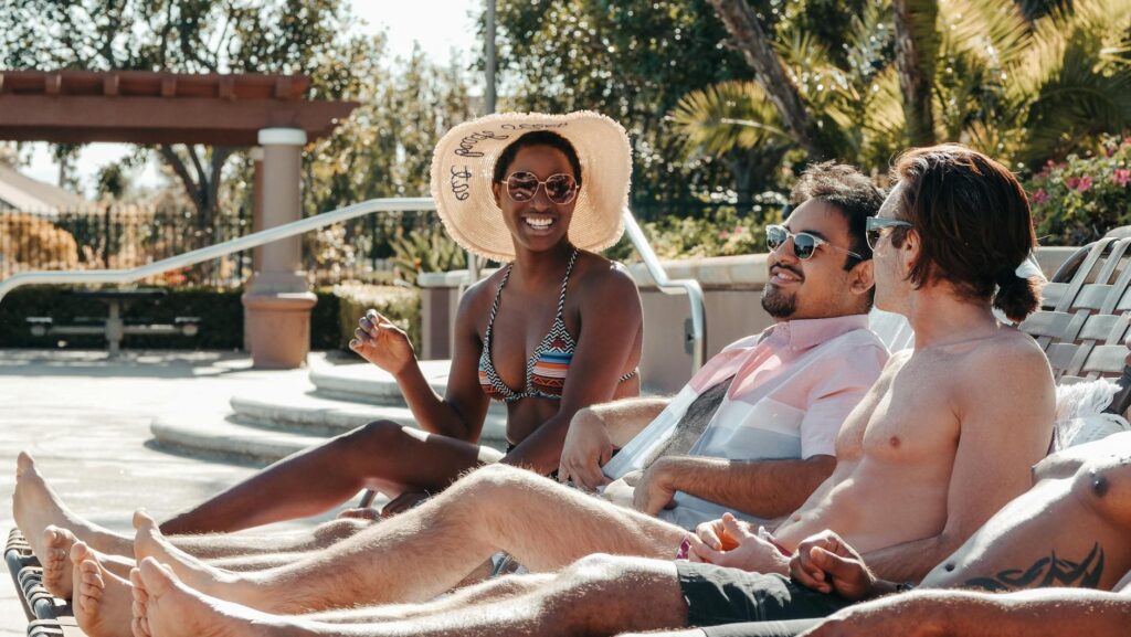 A sunny day at a Las Vegas pool party, highlighting people relaxing on lounge chairs and enjoying the atmosphere. — Vega…