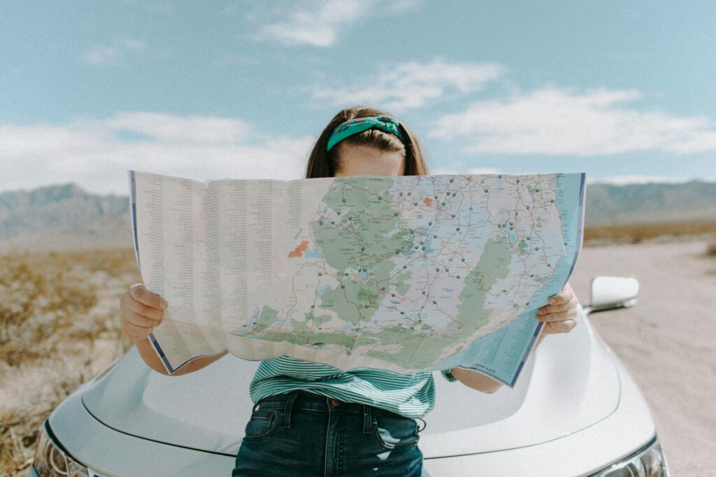 A traveler looking at a map with a budget plan for a Vegas vacation. — save money on Vegas vacation