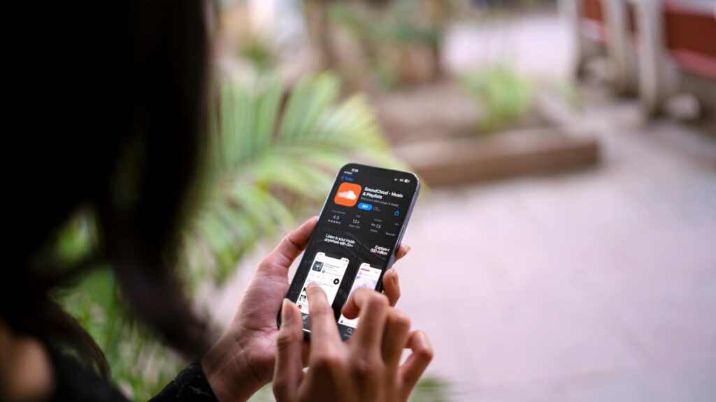 A user browsing through a ticketing app on their smartphone with a show in the background. — last minute show tickets La…