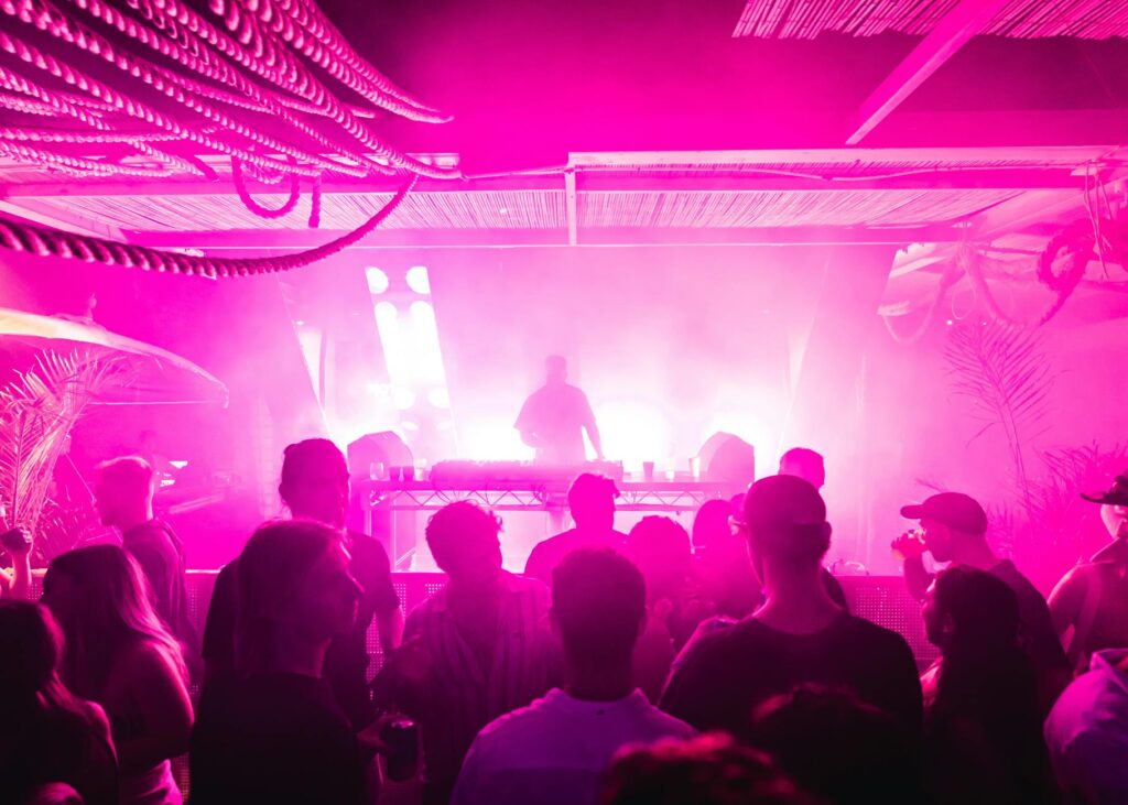 A vibrant nightlife scene at one of the best clubs in Vegas, showcasing a packed dance floor and DJ. — Las Vegas nightcl…