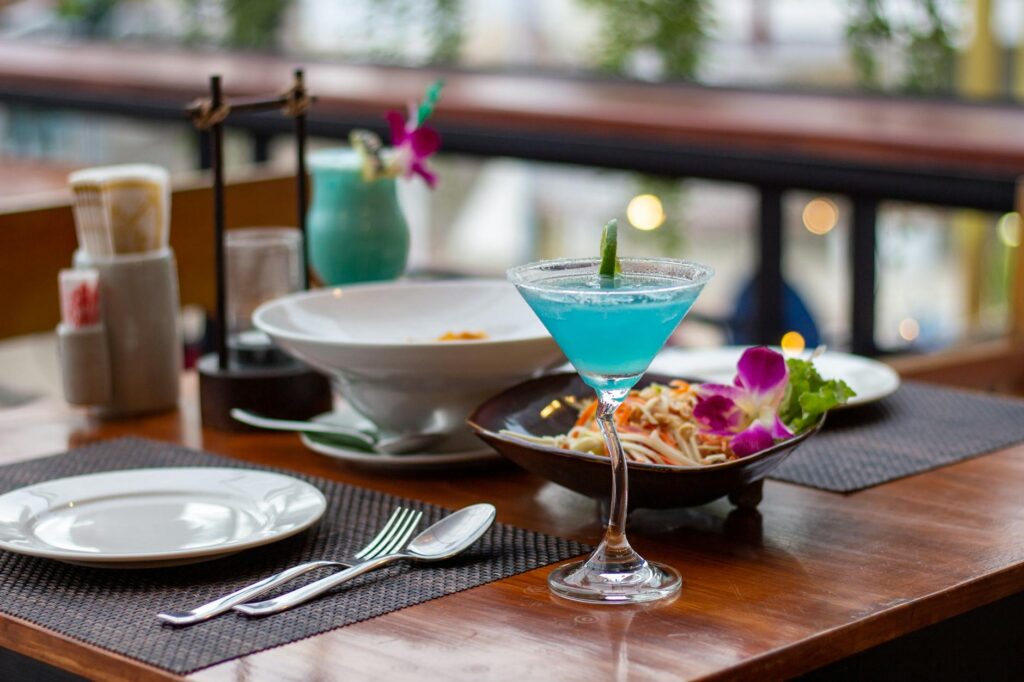 A vibrant table setting with cocktails and dishes from multiple new restaurants in Las Vegas. — new restaurants Las Vega…