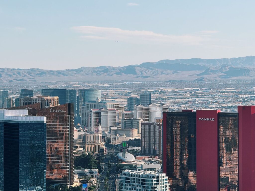 An aerial shot of Las Vegas showcasing its iconic landmarks under clear blue skies. — best time to visit Las Vegas