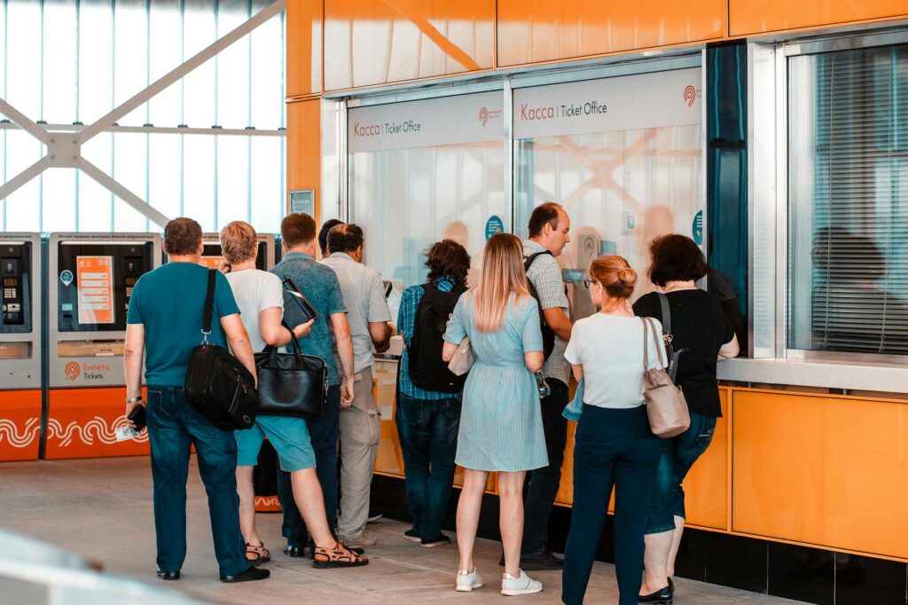 An image of tourists standing in line at a Tix4Tonight kiosk, eager to purchase affordable show tickets. — discount tick…