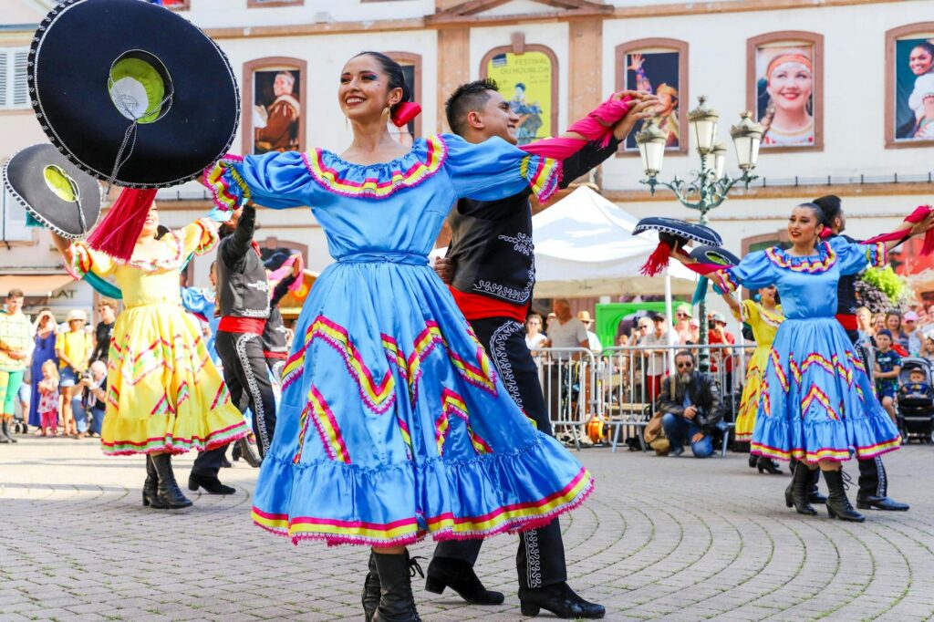 Attendees enjoying a summer festival in Las Vegas with colorful decorations and lively crowds. — best time to visit Las …