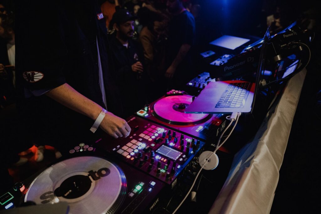 A DJ spinning records in a crowded nightclub, capturing the lively atmosphere of Las Vegas nightlife guide