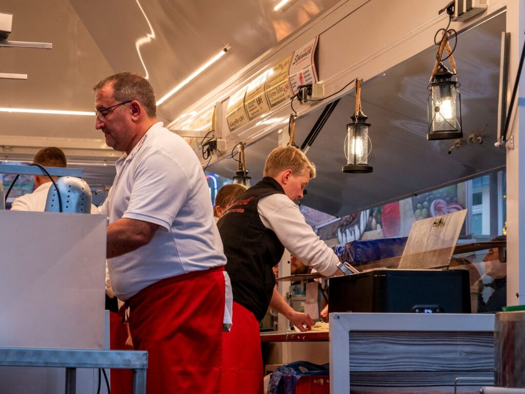 A bustling food truck festival with various vendors and happy customers. — best food trucks in Las Vegas