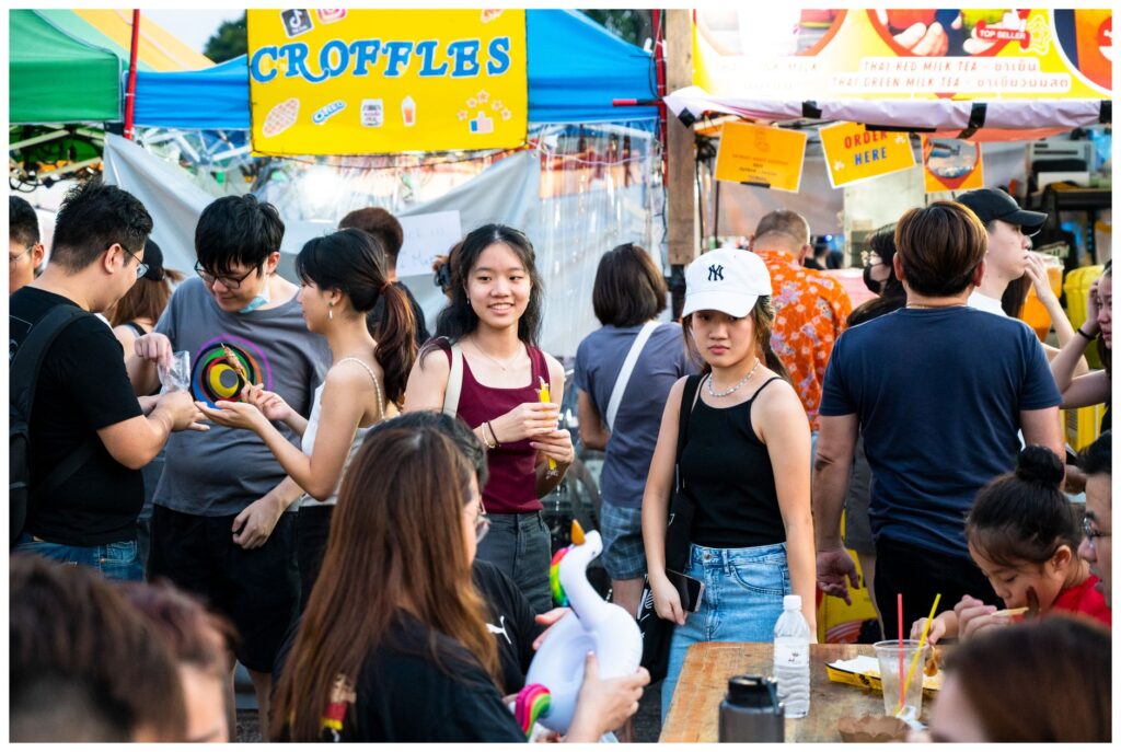 A bustling scene from a culinary festival in Las Vegas with various food stalls and happy guests. — unique restaurants L…