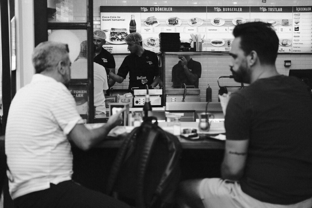 A candid shot of diners enjoying an interactive dining experience, illustrating engagement and fun. — unique restaurants…