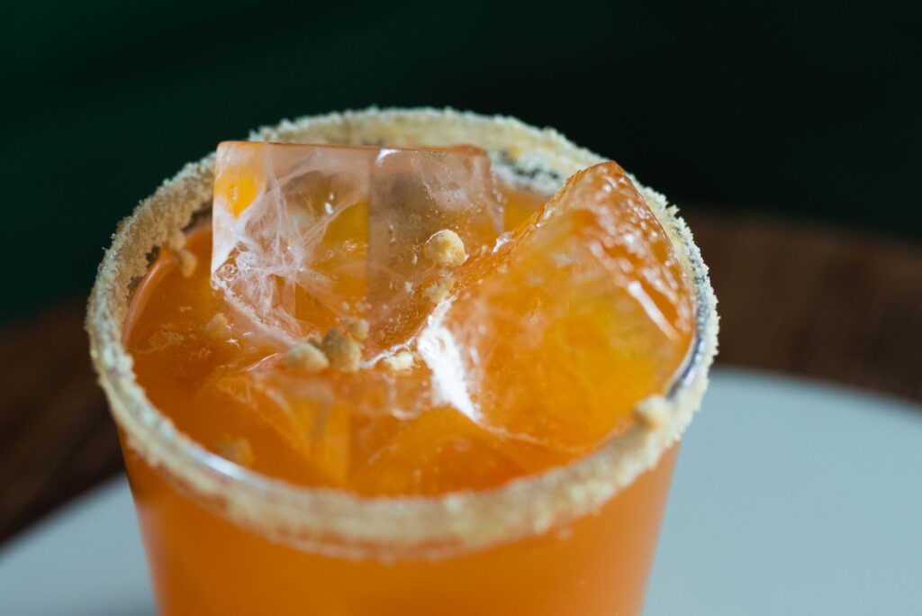 A close-up of a signature cocktail being served at a Las Vegas pool party, highlighting its colorful presentation. — las…