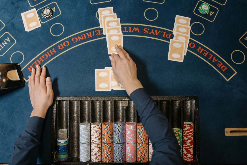 A close-up of casino chips and a dealer at a blackjack table, illustrating the excitement of table games. — las vegas ca…