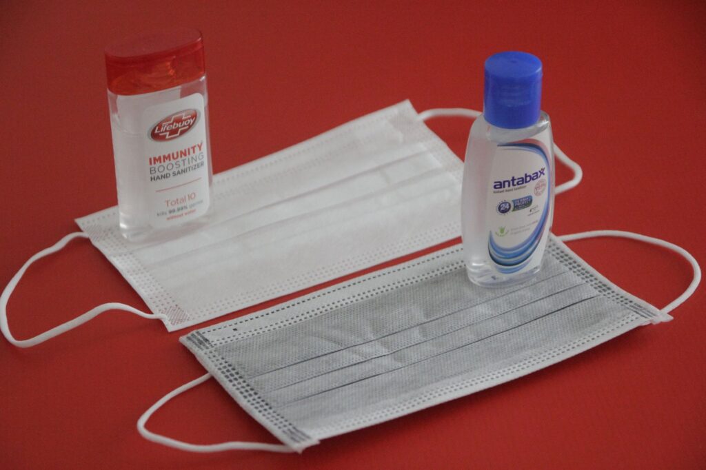 A collection of health and safety items like hand sanitizer, masks, and medications. — packing list for Las Vegas trip