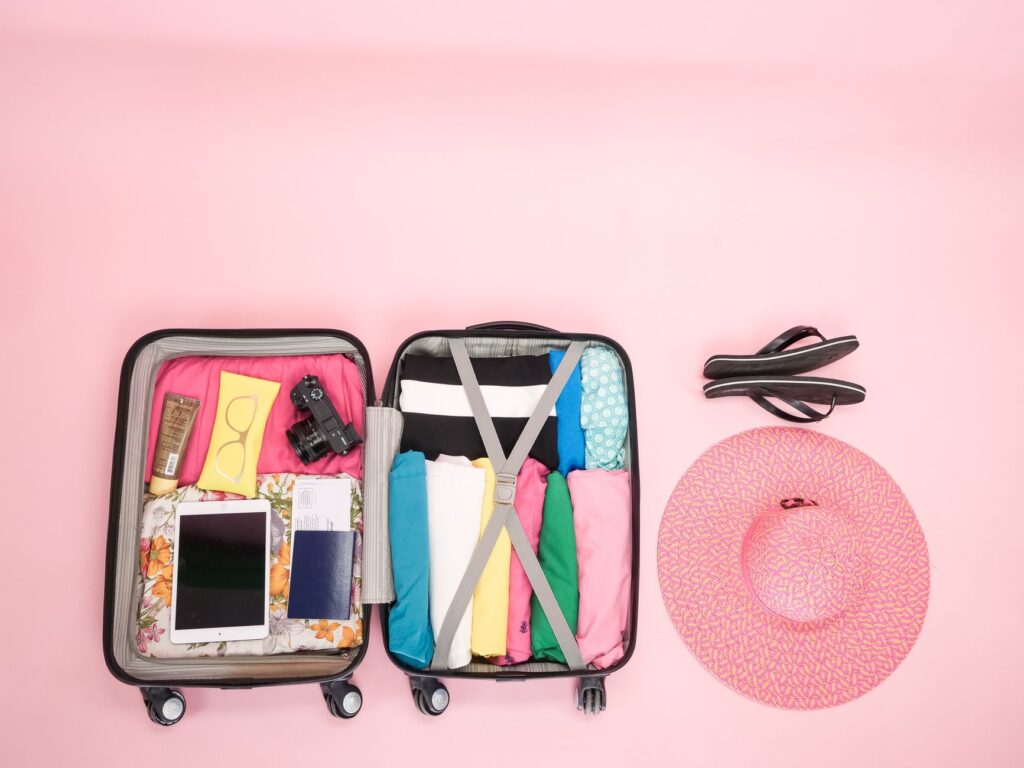 A colorful suitcase packed with summer attire for Las Vegas. — las vegas packing list