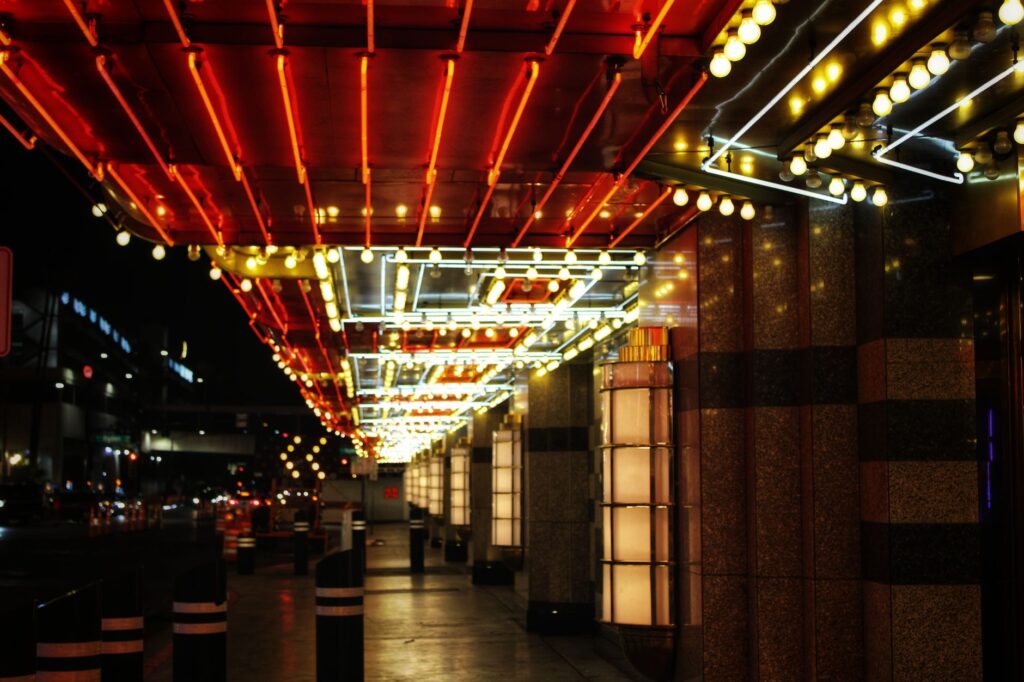 A couple taking a romantic stroll down the Las Vegas Strip at night with neon lights in the background. — romantic thing…
