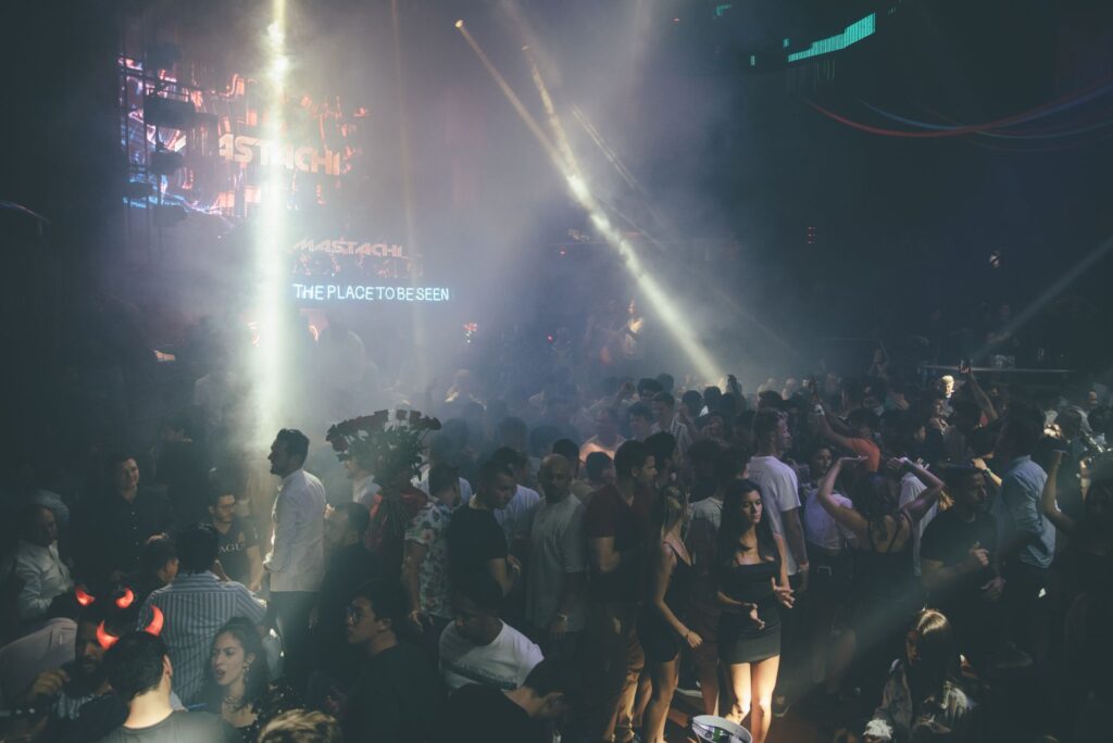 A crowded Vegas club with vibrant lights and people dancing. — Las Vegas nightlife