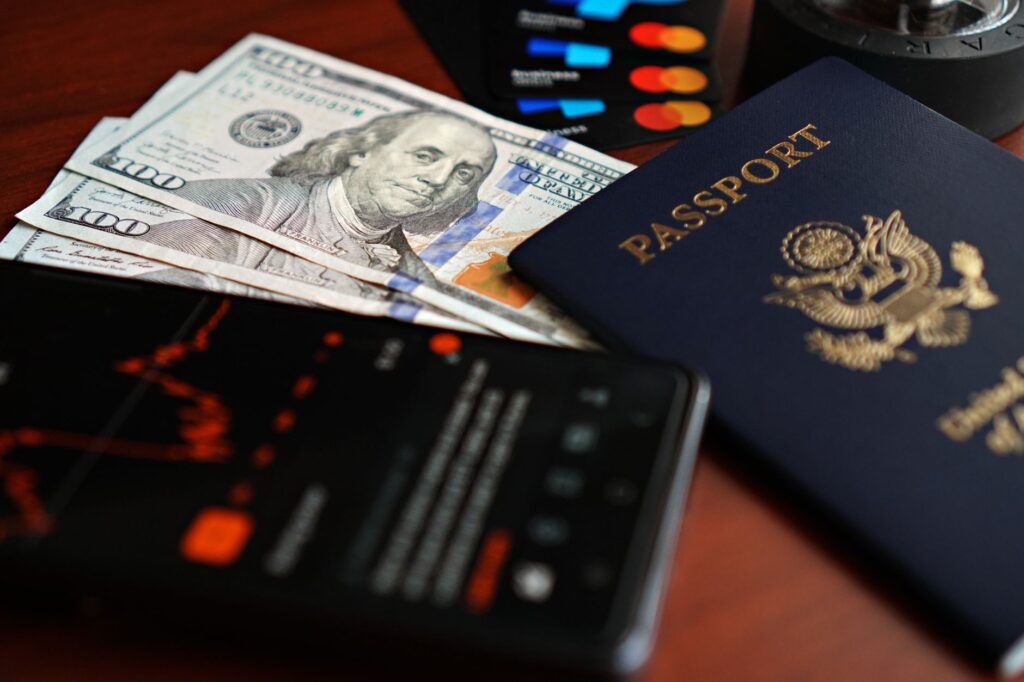 A flat lay of essential travel documents, cash, and credit cards for a Vegas trip. — packing list for Las Vegas trip