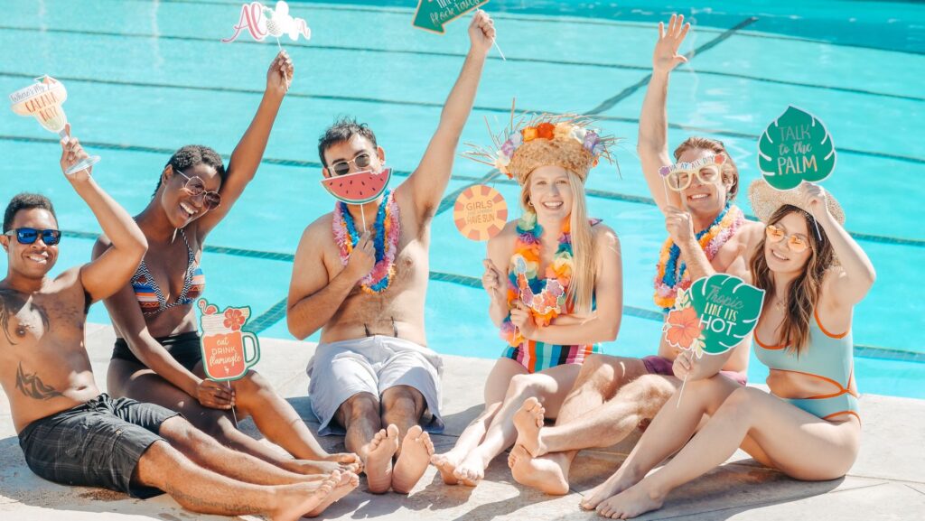 A group of friends enjoying a pool party in Las Vegas, showcasing casual summer attire. — what to wear las vegas