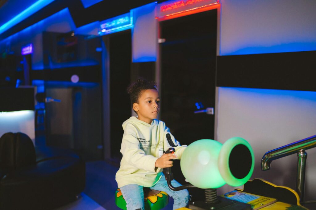 A group of kids playing arcade games in a popular indoor entertainment center in Vegas. — family activities Las Vegas